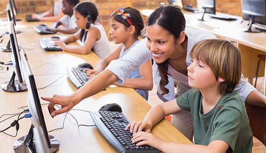 Students learning in a bilingual classroom setting using English and Indonesian